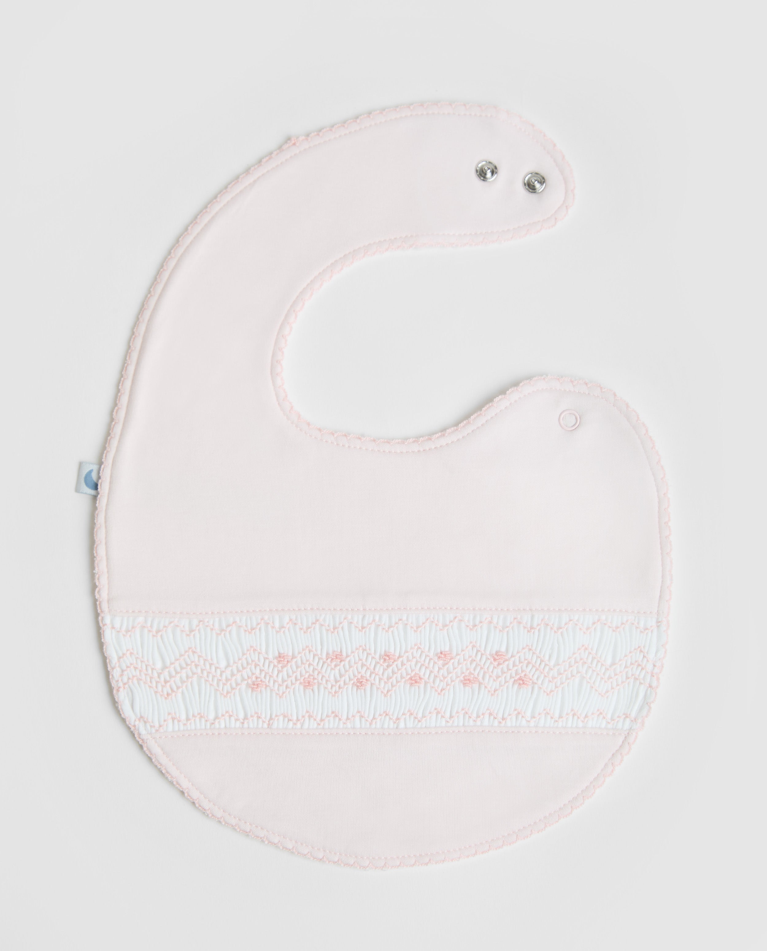 Bavoir rose à smocks
