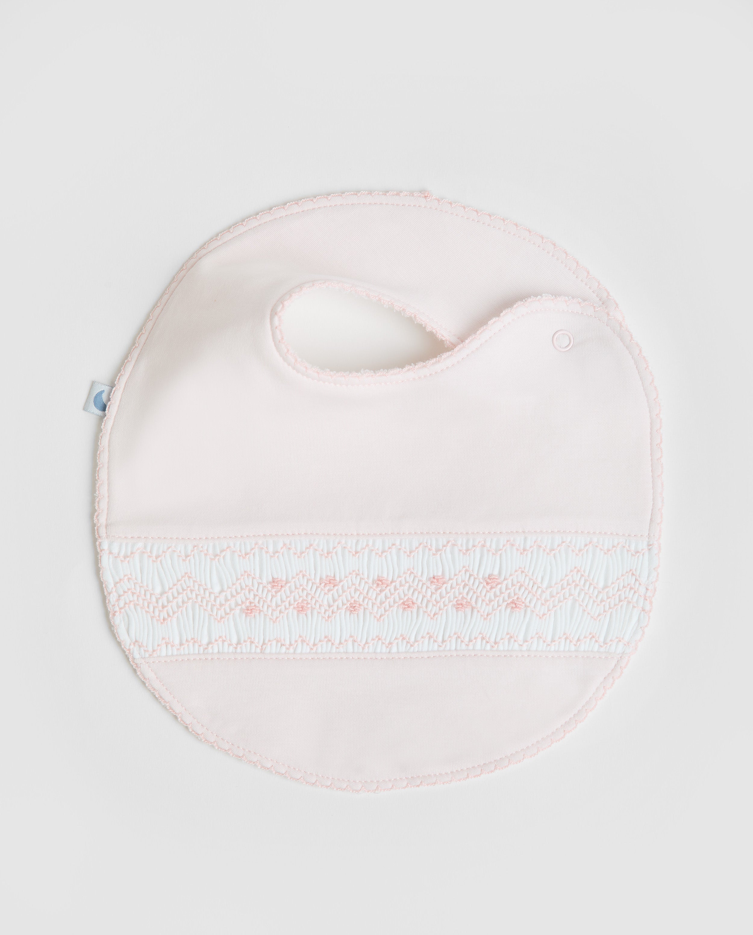 Bavoir rose à smocks